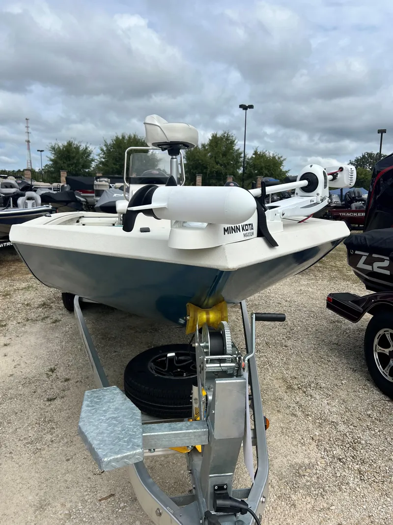 Slide: The Image of 2024 Ranger RB200 boat with Minn Kota motor on trailer, parked outdoors. - 5