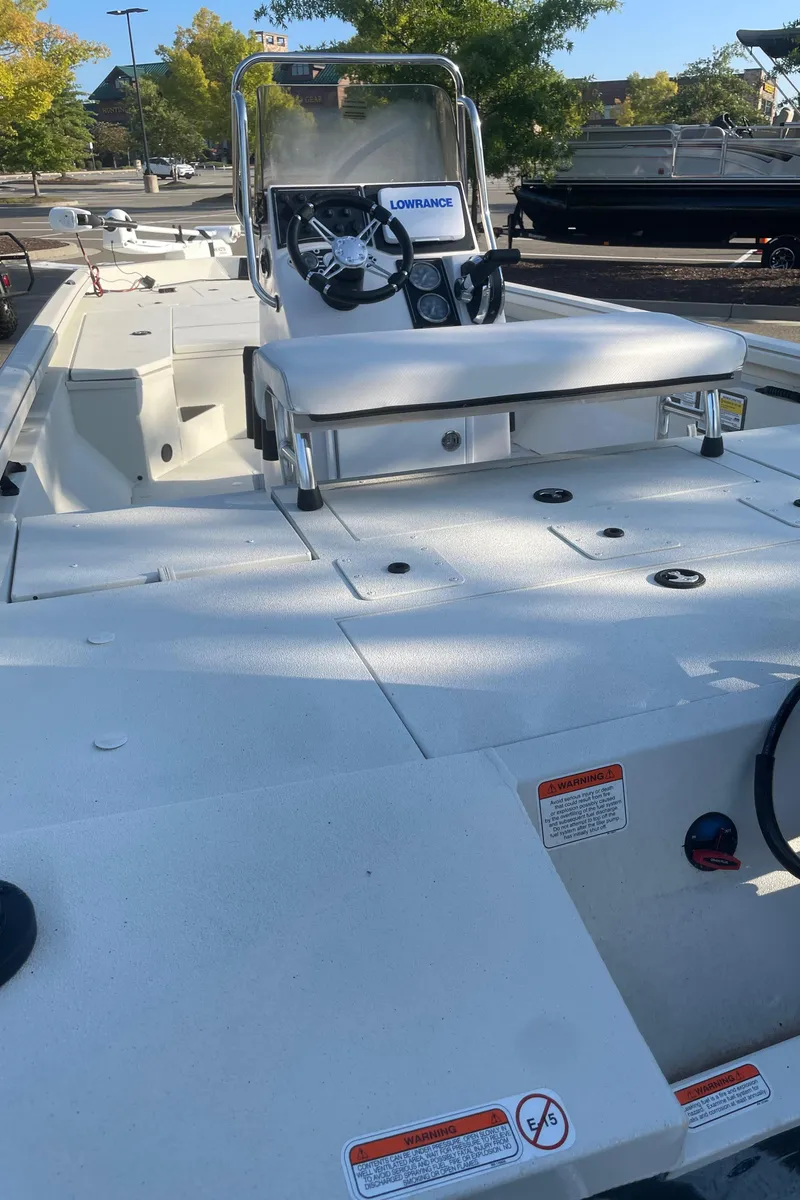 Slide: The Image of 2024 Ranger RB200 boat with center console and seating, parked outdoors. - 2