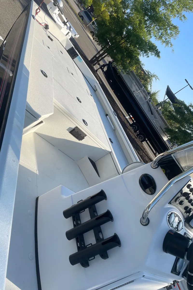 Slide: The Image of 2024 Ranger RB200 boat with sleek white deck and modern controls. - 3