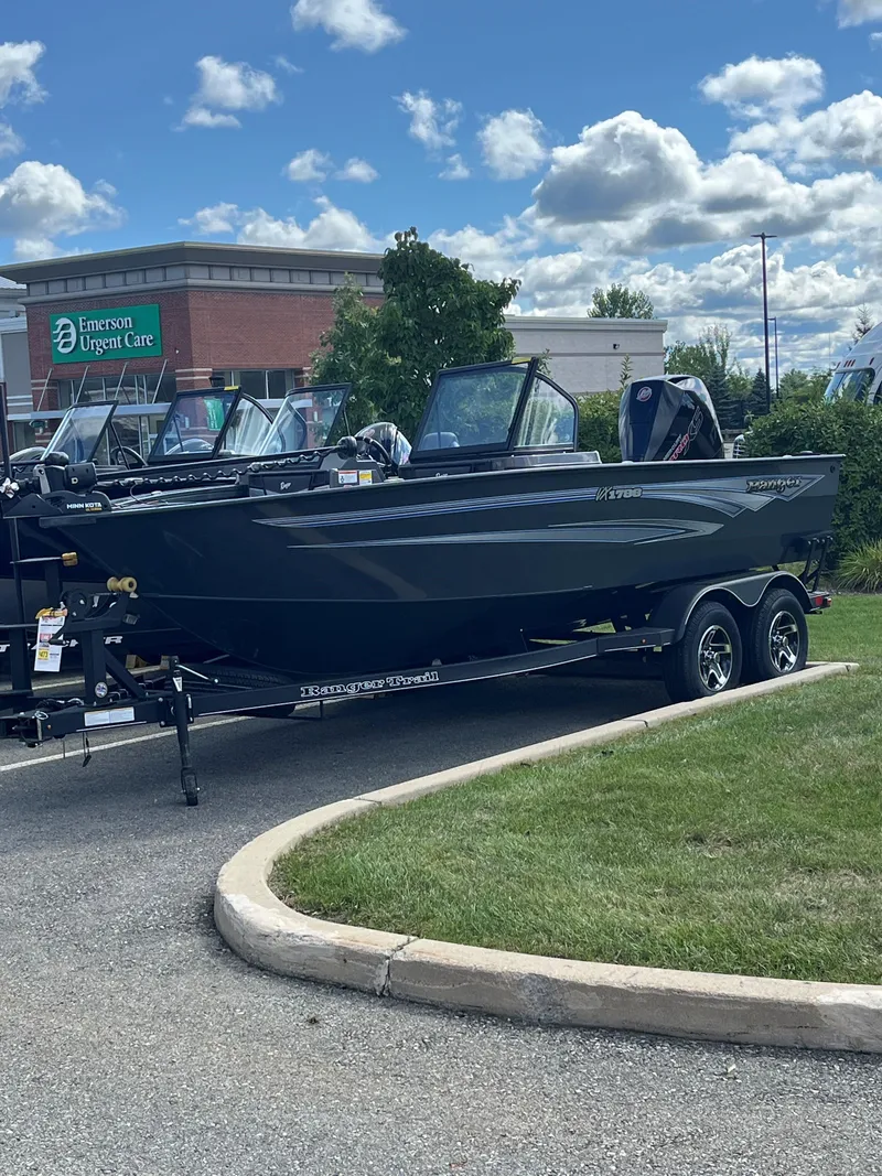 The Image of 2024 Ranger VX1788 WT boat on trailer, parked outdoors under a cloudy sky. - 0