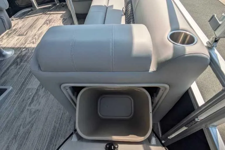 Slide: The Image of 2024 Ranger Reata 223C boat interior with storage compartment and cup holder. - 4