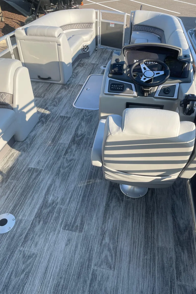 Slide: The Image of 2024 Ranger Reata 223C boat interior with modern seating and steering console. - 4
