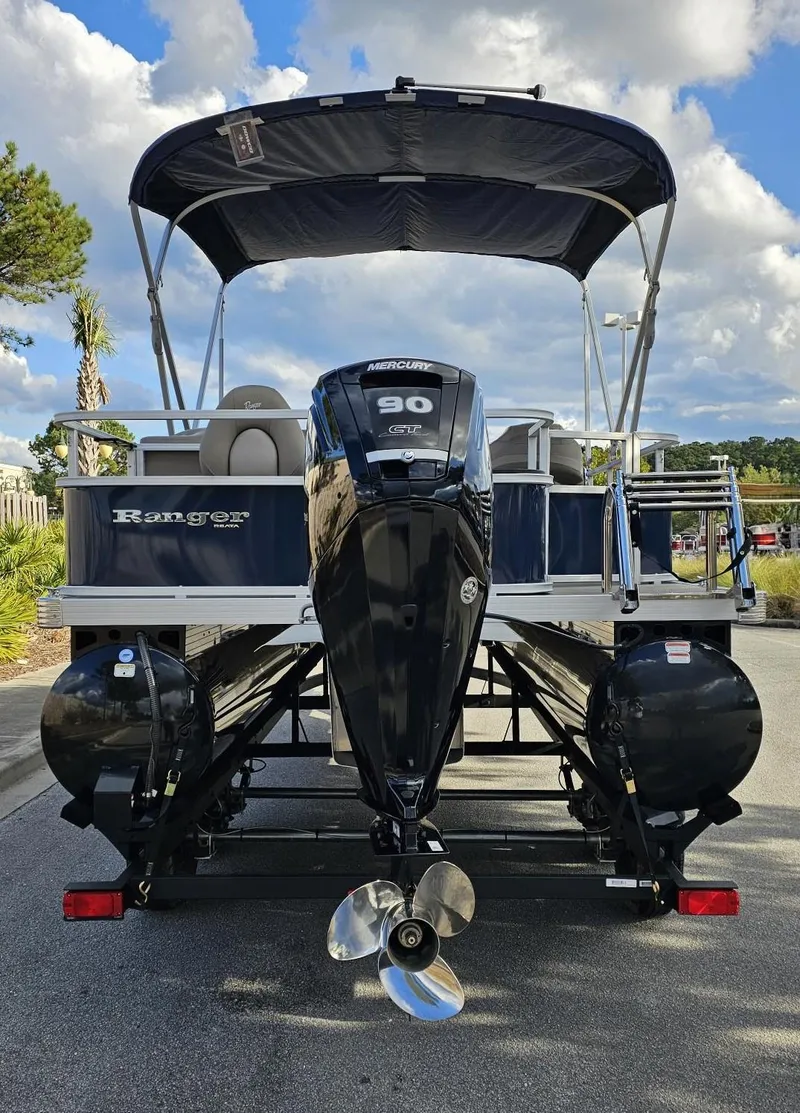 Slide: The Image of 2024 Ranger Reata 200F pontoon boat with canopy and outboard motor. - 4