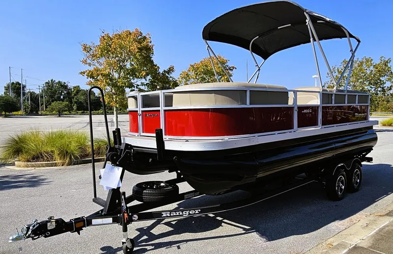 Slide: The Image of 2024 Ranger Reata 200C pontoon boat with red exterior on a trailer. - 6