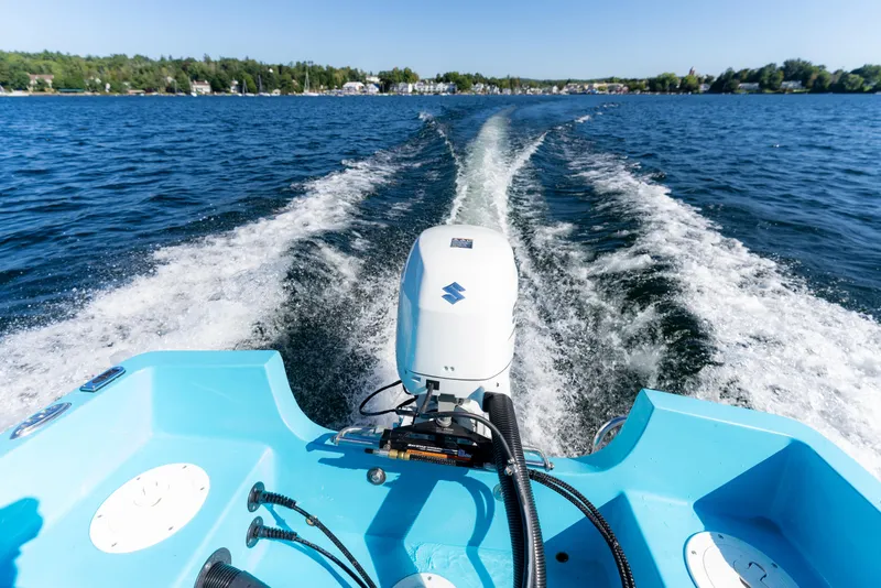 Slide: The Image of 2024 Wolfeboro Classic 15 boat cruising on a lake with a powerful outboard motor. - 11