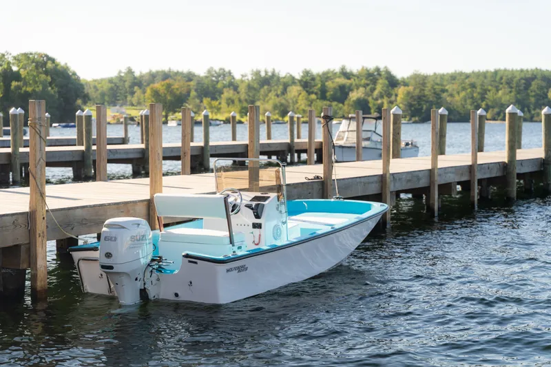 Slide: The Image of 2024 Wolfeboro Classic 15 boat docked by a wooden pier on a sunny day. - 4