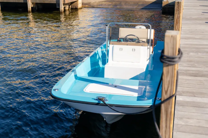 Slide: The Image of 2024 Wolfeboro Classic 15 boat docked on calm water. - 7