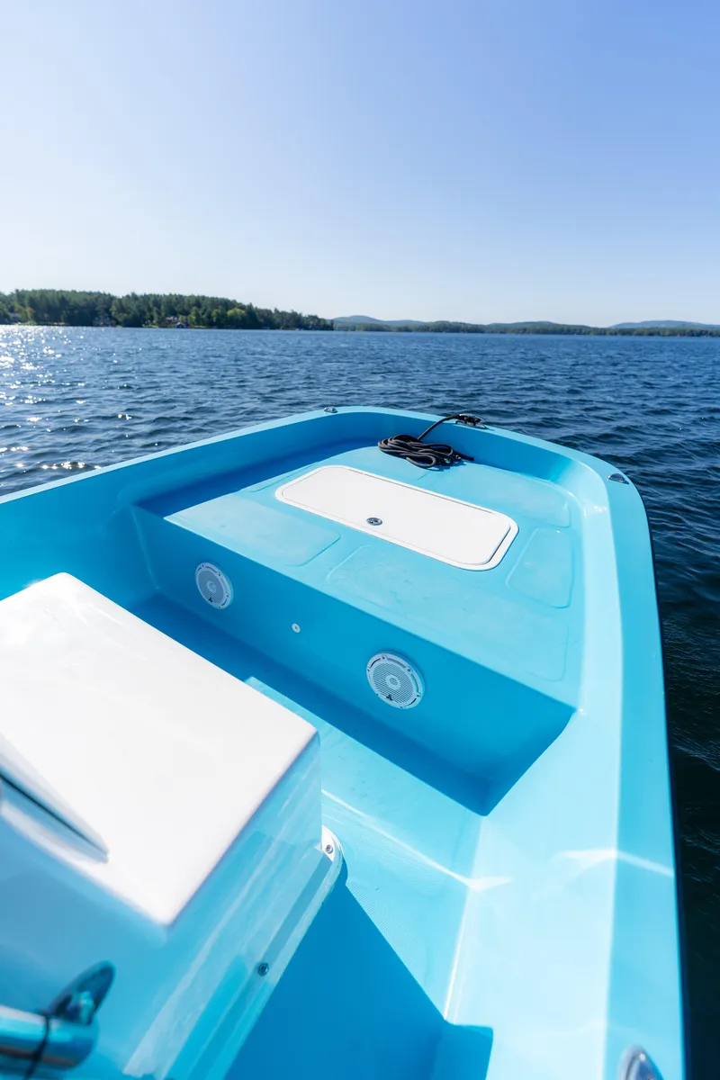 Slide: The Image of 2024 Wolfeboro Classic 15 boat on serene lake under clear blue sky. - 8