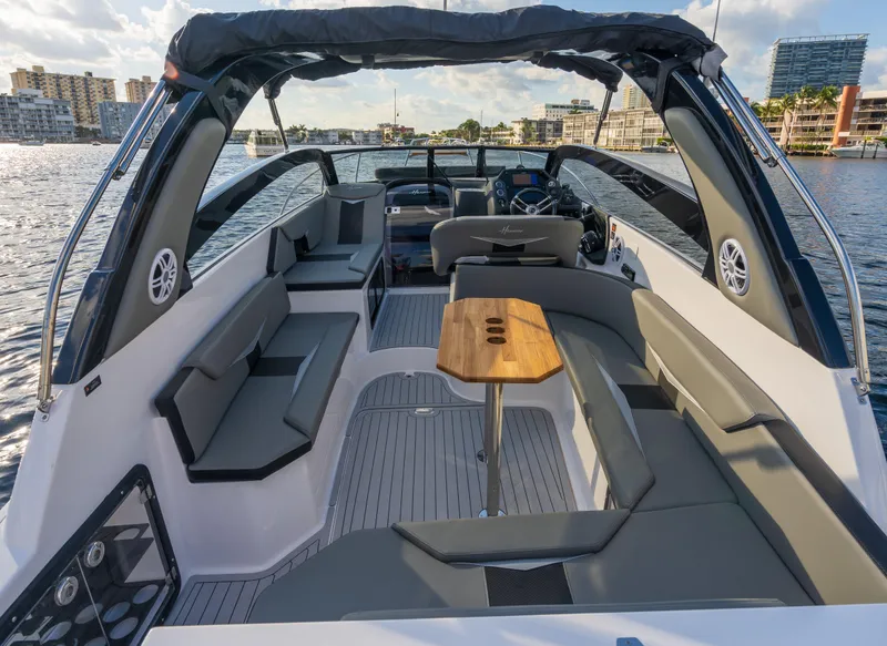 Slide: The Image of Luxurious 2025 Hanover 305 boat interior with sleek seating and wooden table on a sunny day. - 3