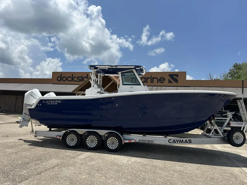 Slide: The Image of 2024 Caymas 30CAT boat on trailer at Dockside Marine under a cloudy sky. - 0