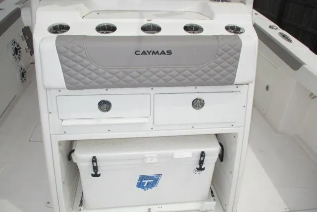 Slide: The Image of 2024 Caymas 30CAT boat interior with storage compartments and cooler. - 11