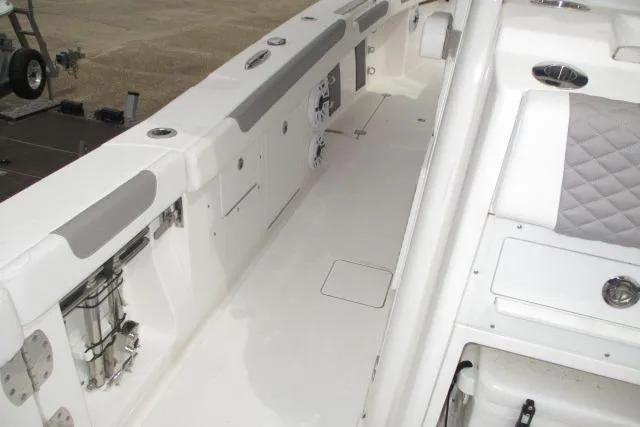 Slide: The Image of 2024 Caymas 30CAT boat interior with white seating and storage compartments. - 12