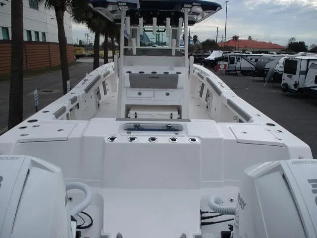 Slide: The Image of 2024 Caymas 30CAT boat with dual Mercury engines, docked in a marina. - 3