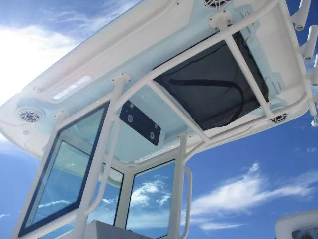 Slide: The Image of 2024 Caymas 30CAT boat roof with speakers and hatch under clear blue sky. - 6