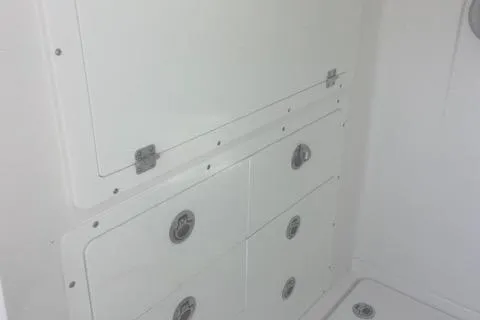 Slide: The Image of 2024 Caymas 30CAT boat storage compartments with secure latches and sleek design. - 7