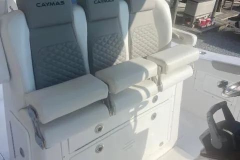 Slide: The Image of 2024 Caymas 30CAT boat interior with cushioned seating and storage compartments. - 8