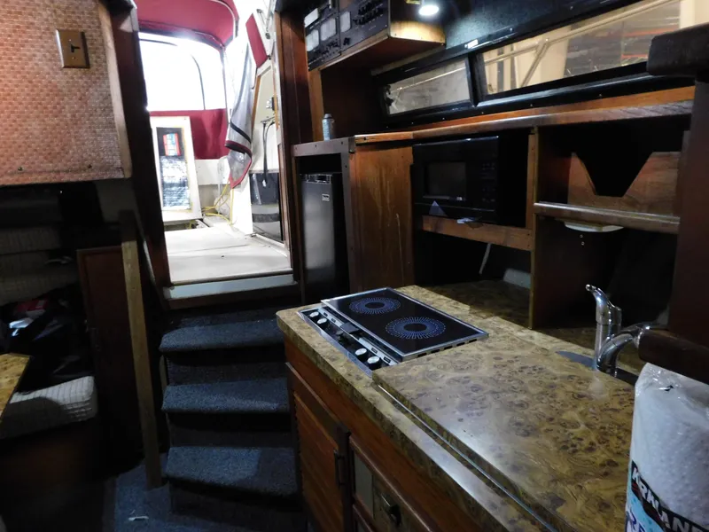 Slide: The Image of Interior of 1984 Cruisers International 296 Avanti Vee boat with kitchen and stairs. - 10