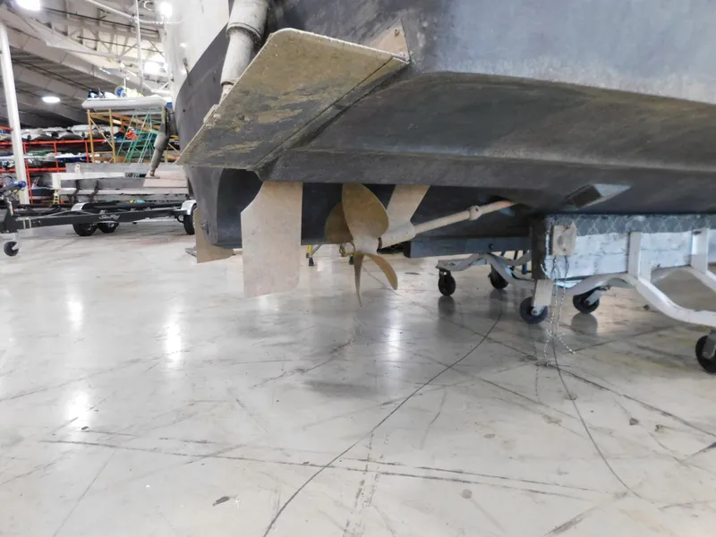 Slide: The Image of 1984 Cruisers International 296 Avanti Vee boat propeller in a workshop setting. - 3