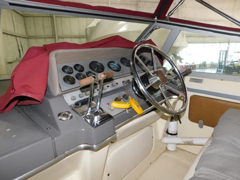 Slide: The Image of 1984 Cruisers International 296 Avanti Vee boat cockpit with steering wheel and control panel. - 4