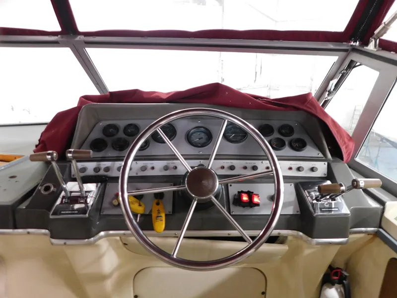 Slide: The Image of 1984 Cruisers International 296 Avanti Vee boat dashboard with steering wheel and controls. - 5