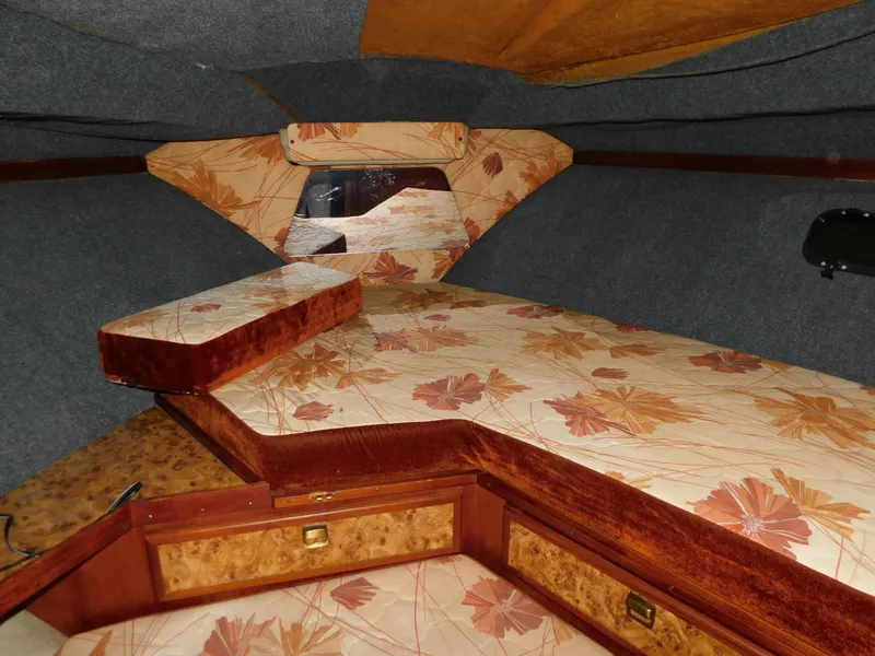 Slide: The Image of 1984 Cruisers International 296 Avanti Vee cabin interior with floral upholstery and wooden accents. - 8