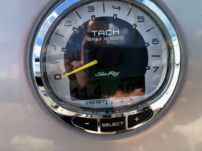 Slide: The Image of Tachometer of 2012 Sea Ray 240 Sundeck showing RPM and voltage. - 14