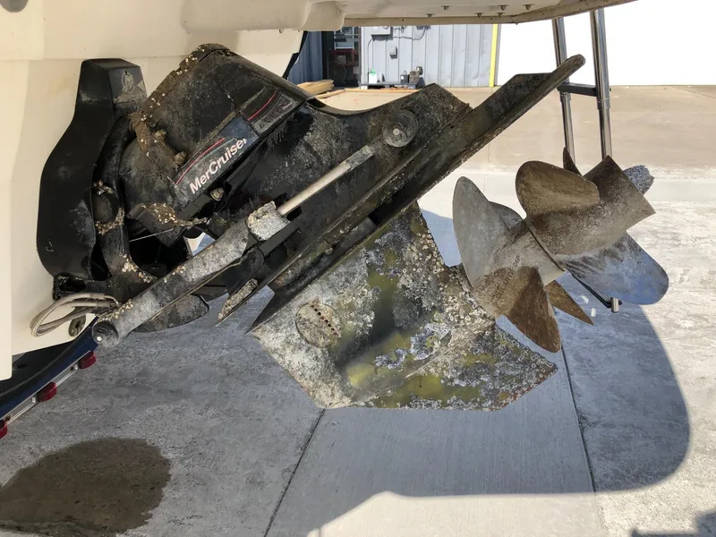 Slide: The Image of 2012 Sea Ray 240 Sundeck boat propeller with visible wear and marine growth. - 4