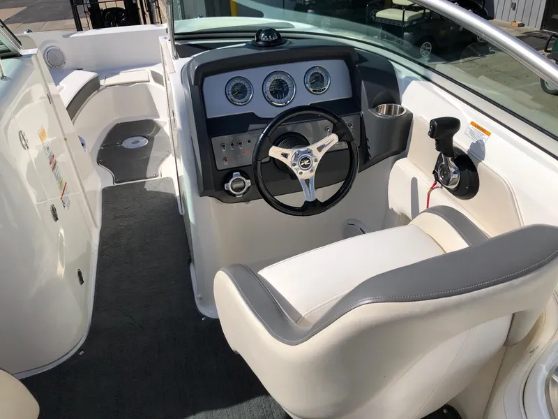 Slide: The Image of 2012 Sea Ray 240 Sundeck boat interior with steering wheel and dashboard. - 8