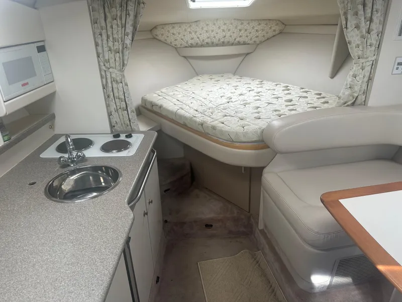 Slide: The Image of Interior of a 2000 Formula 31 Performance Cruiser with kitchen and sleeping area. - 9