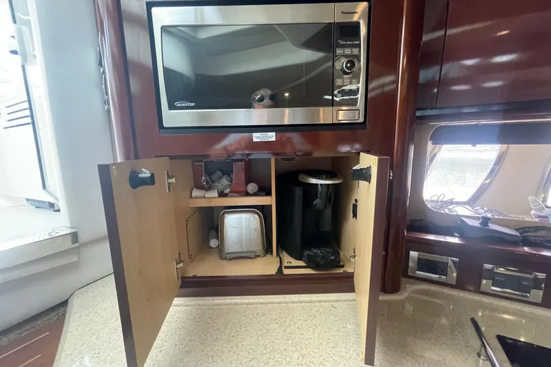 Slide: The Image of 2009 Sea Ray 40 Sundancer kitchen with microwave and storage cabinets. - 17