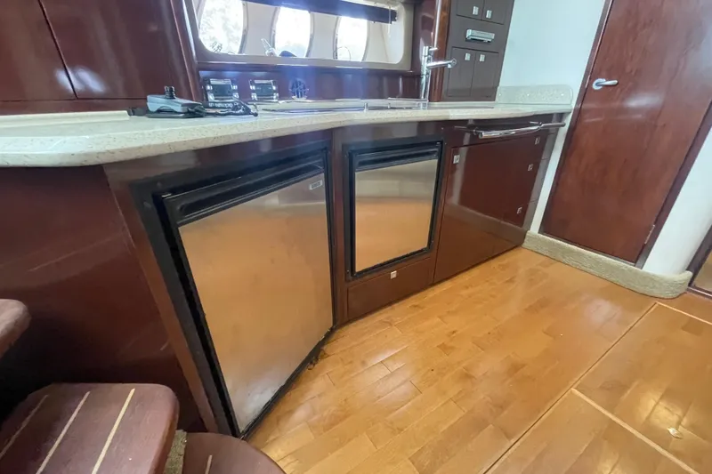Slide: The Image of Luxurious 2009 Sea Ray 40 Sundancer yacht kitchen with wood cabinetry and stainless steel appliances. - 18