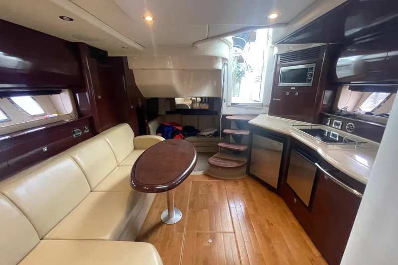 Slide: The Image of Luxurious interior of 2009 Sea Ray 40 Sundancer yacht with modern kitchen and seating area. - 19