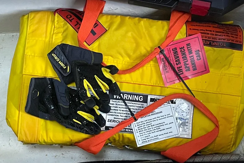 Slide: The Image of Yellow life raft with gloves on a 2009 Sea Ray 40 Sundancer boat. - 21