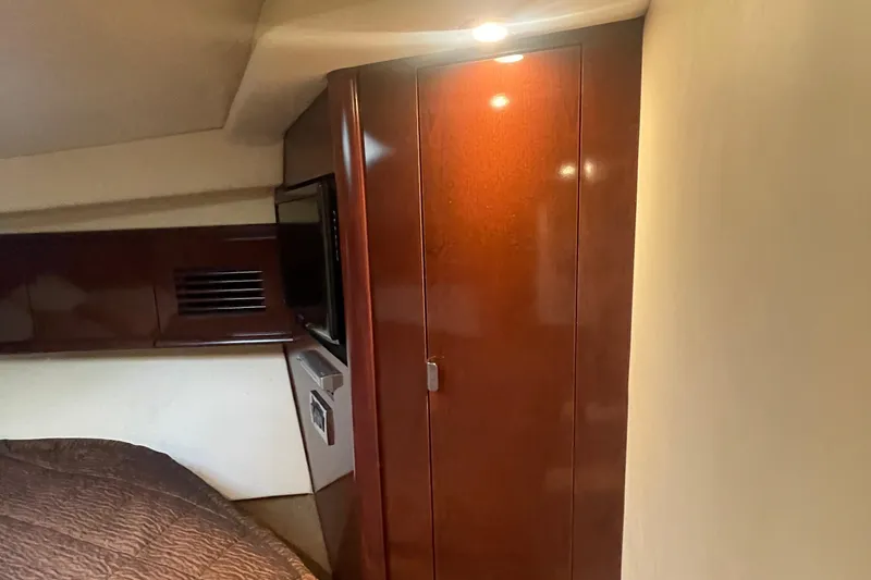 Slide: The Image of Interior cabin of 2009 Sea Ray 40 Sundancer with wood paneling and cozy lighting. - 26