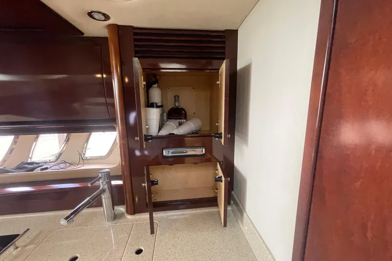 Slide: The Image of 2009 Sea Ray 40 Sundancer yacht interior with open cabinet and countertop. - 32