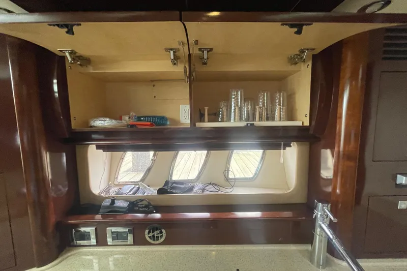 Slide: The Image of Interior of 2009 Sea Ray 40 Sundancer with open cabinets and countertop. - 33
