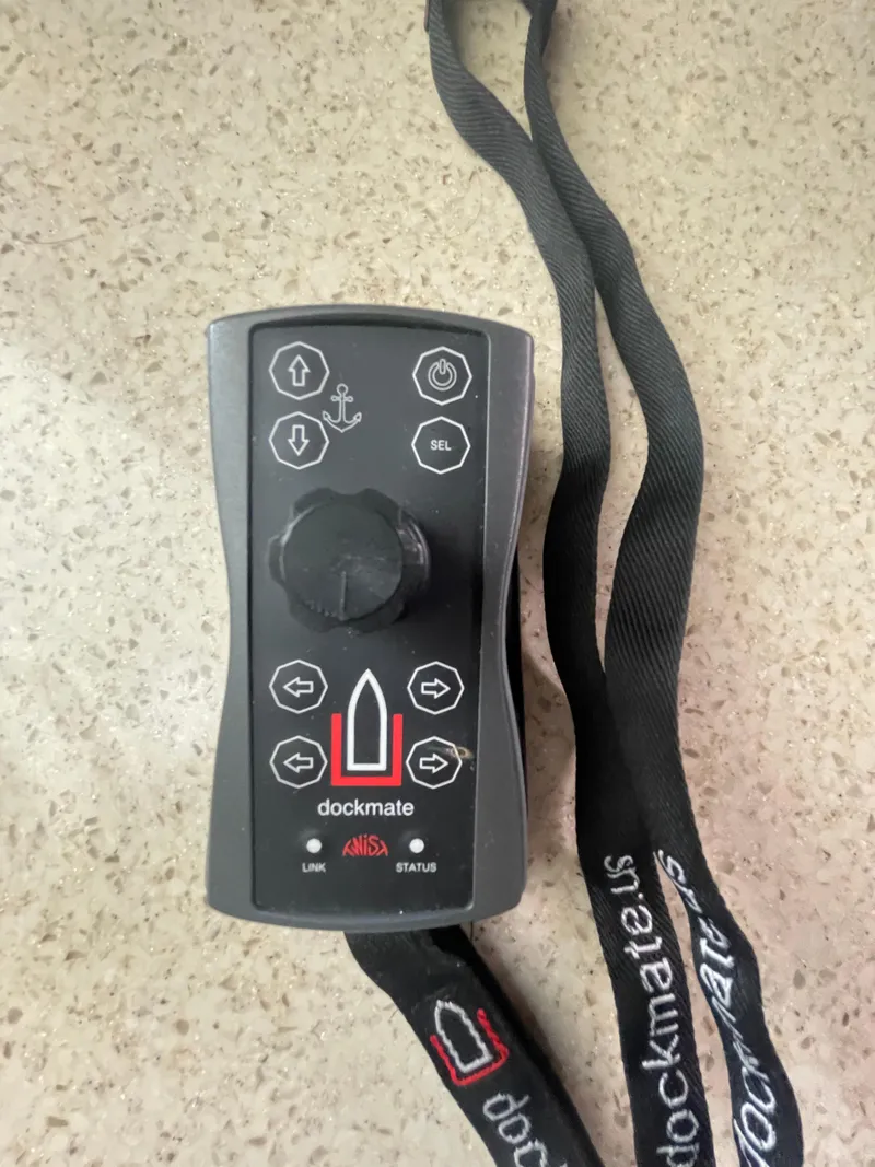 Slide: The Image of Dockmate remote control for 2009 Sea Ray 40 Sundancer on a beige surface. - 34