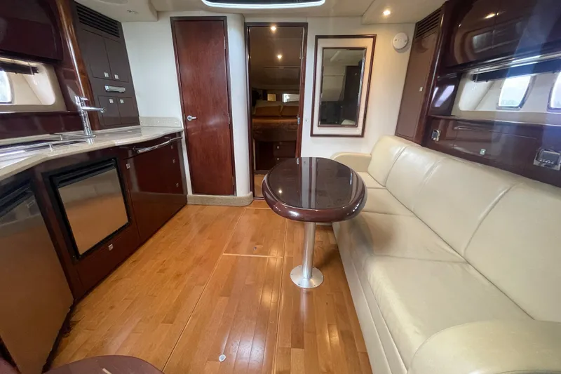 Slide: The Image of Luxurious interior of 2009 Sea Ray 40 Sundancer yacht with leather seating and wooden flooring. - 36