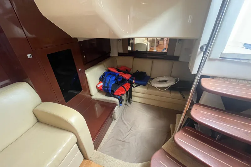 Slide: The Image of Interior of 2009 Sea Ray 40 Sundancer with seating, life jackets, and stairs. - 38