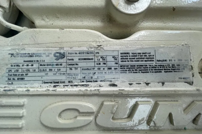 Slide: The Image of Close-up of a Cummins engine label on a 2009 Sea Ray 40 Sundancer. - 48
