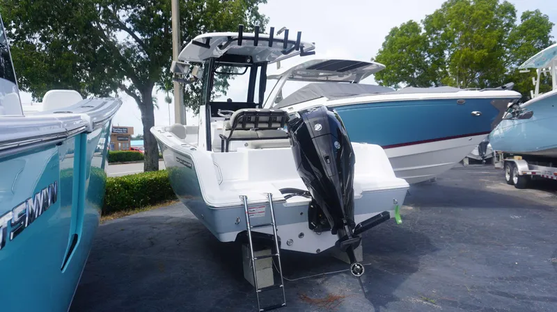 Slide: The Image of 2025 Sportsman 212 Open boat with outboard motor, parked outdoors. - 3