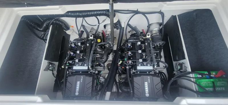 Slide: The Image of 2023 Yamaha SX220 boat engine compartment with dual engines and wiring. - 10