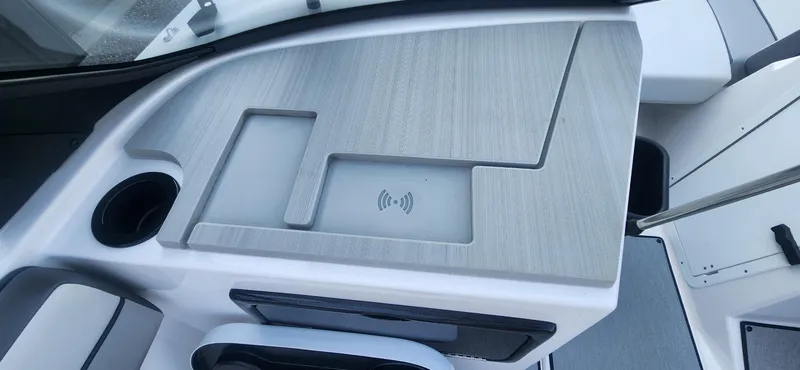 Slide: The Image of 2023 Yamaha SX220 boat console with wireless charging pad and cup holder. - 13