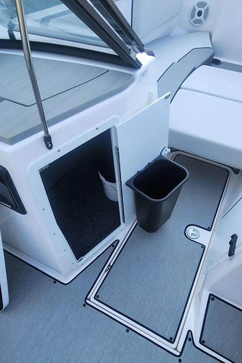 Slide: The Image of 2023 Yamaha Boats SX220 interior with storage compartment and seating area. - 14