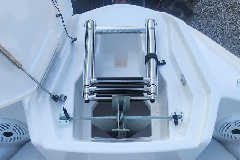 Slide: The Image of 2023 Yamaha SX220 boat anchor compartment with ladder and storage. - 15