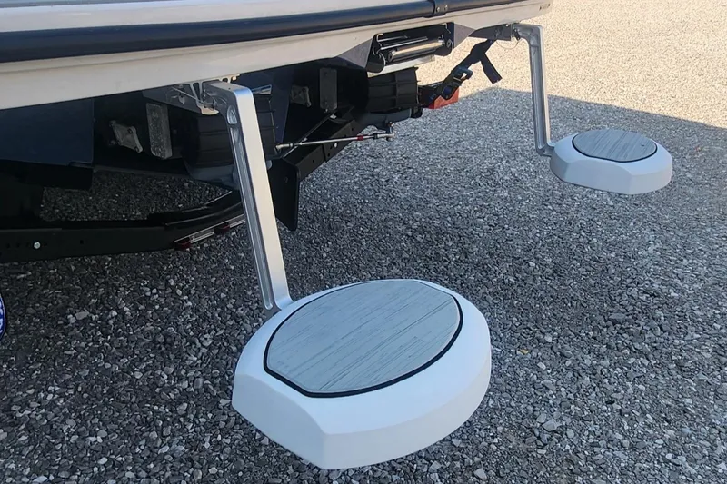 Slide: The Image of 2023 Yamaha Boats SX220 swim platform steps on gravel surface. - 16