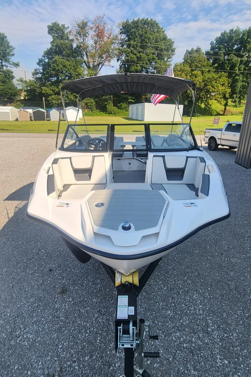 Slide: The Image of 2023 Yamaha Boats SX220 on trailer, sleek design, outdoor setting. - 3