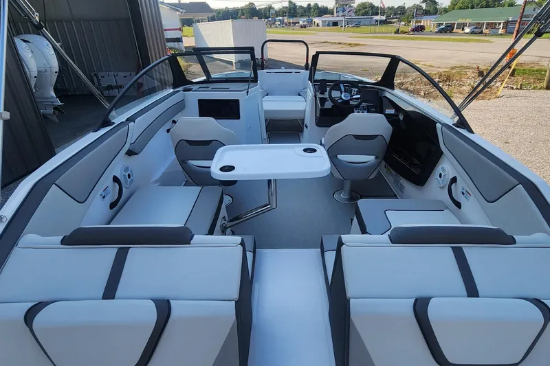 Slide: The Image of 2023 Yamaha Boats SX220 interior with sleek seating and modern dashboard. - 4