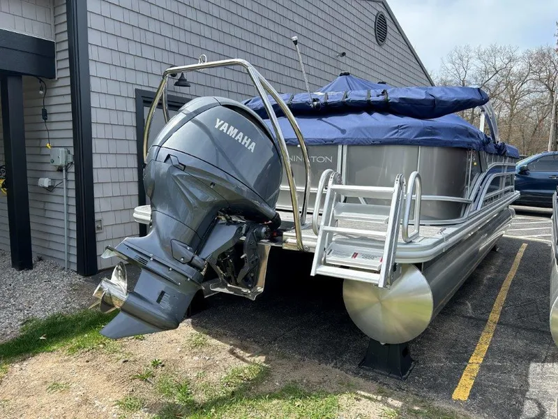 Slide: The Image of 2024 Bennington 22SSRSR pontoon boat with Yamaha outboard motor, parked outdoors. - 4