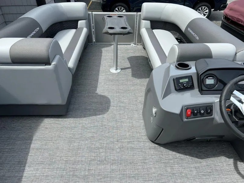 Slide: The Image of 2024 Bennington 22SSRSR pontoon boat interior with gray seating and modern console. - 5
